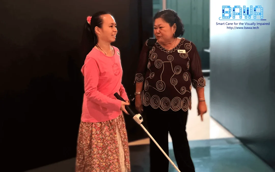 Felicia (born blind), accompanied by Annie Soon (Orientation and Mobility Specialist), experiencing the BAWA Cane.